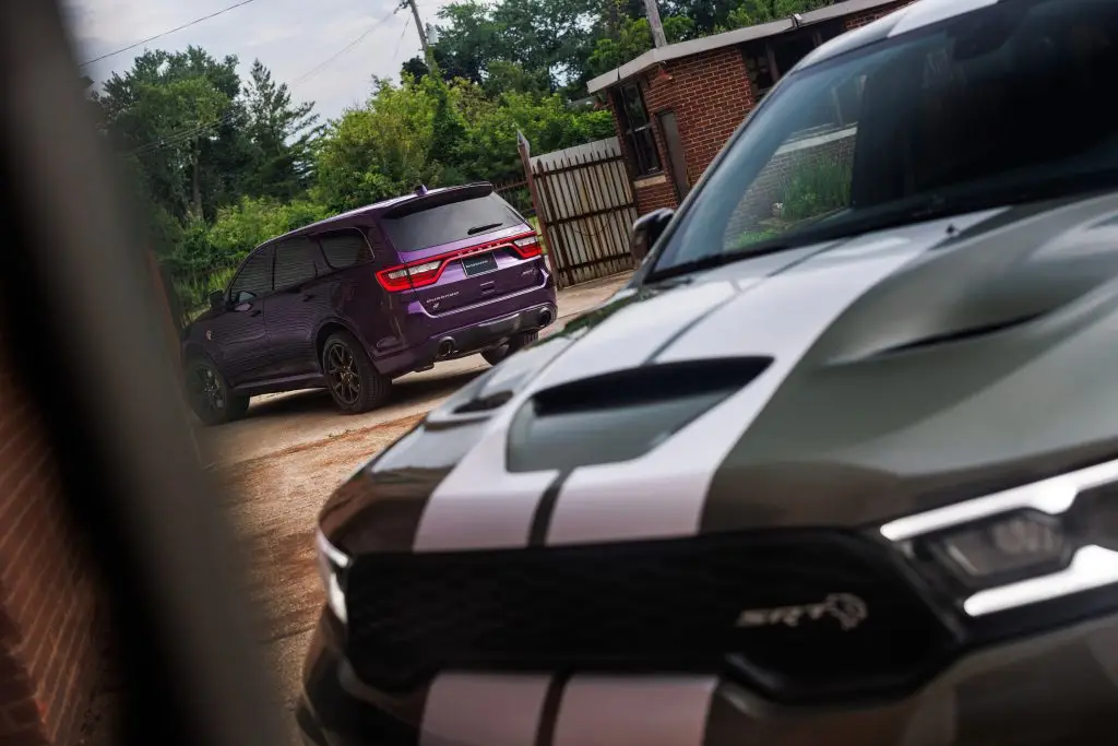 2026 Dodge Durango SRT Hellcat Jailbreak in Green Machine (front). A Jailbreak Custom Color program will allow select Dodge customers to paint their Durango SRT Hellcat Jailbreak in nearly any color imaginable, including Stryker Purple (shown at rear).
